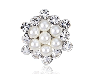 Detailed view of flower brooch featuring seven white pearls and twelve sparkling rhinestones