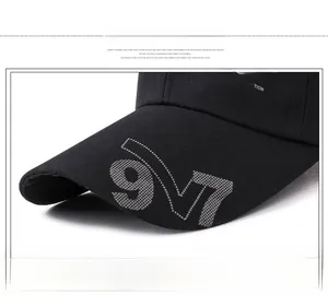 Detailed macro view of black baseball cap brim with white printed 97 and Sport Classic text