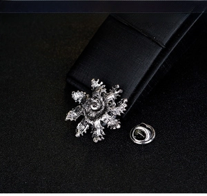 Detailed back view of snowflake lapel pin with butterfly clasp in antique silver finish