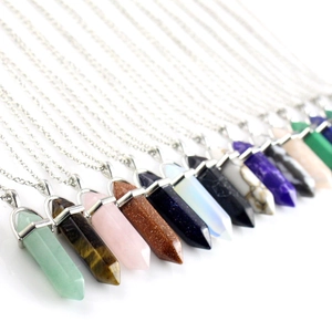 Macro view of assorted hexagonal crystal pillar pendants on silver chain necklaces