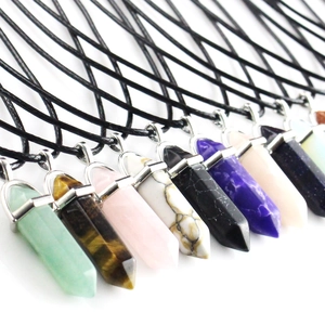 Close-up of hexagonal crystal point necklaces in various natural stones with leather cords