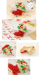 Detail view showing red rhinestone Christmas boot brooch with golden base and holly leaves