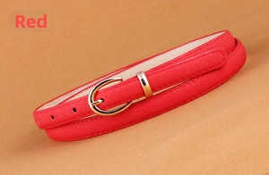 Close-up of a slim red faux leather belt featuring a polished gold semicircular buckle