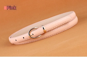 Detailed view of pink faux leather belt with a golden horseshoe buckle for women