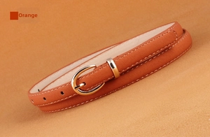 Detail of camel PU leather belt with lychee texture and metallic needle buckle
