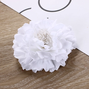 Detailed close-up of white silk peony flower hair clip for hanfu on a wooden surface