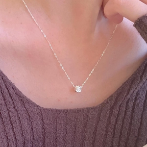Minimalist 925 sterling silver necklace with brushed square pendant on a female model