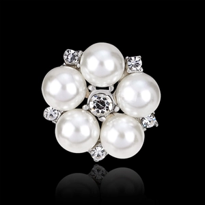 Elegant flower pearl brooch with sparkling rhinestones on a reflective black background