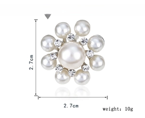 Detail shot of a pearl flower brooch with rhinestones measuring 2.7cm by 2.7cm