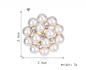 Detailed view of flower-shaped brooch with white pearls and rhinestones 2.4cm size