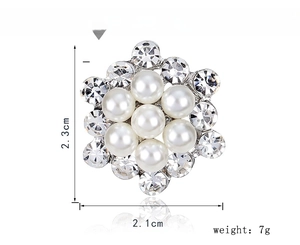 Detail view of 2.3cm x 2.1cm silver floral brooch with white pearls and crystals