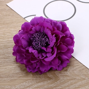 Top view of a purple fabric peony hair clip featuring layered petals and intricate stamens