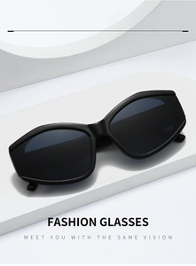 Close-up of stylish black oversized polygon sunglasses on white geometric pedestal