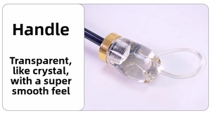 Detail of the transparent umbrella handle featuring embedded gold foil and metallic ring