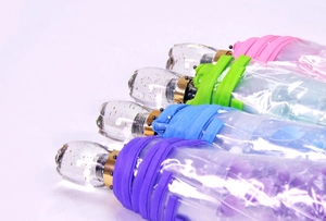 Detail of colorful foldable transparent umbrellas with glitter crystal handles