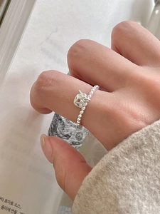 Detailed close-up of a 925 sterling silver beaded ring featuring a heart lock charm