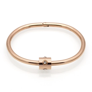 Close-up of rose gold stainless steel bangle with diamond slider and polished finish