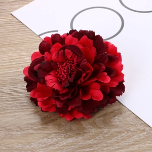 Detailed close-up of layered red peony hair clip with realistic fabric petals and stamens