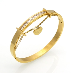 Close-up of 18k gold-plated bangle with Forever Love heart charm and crystal inlay
