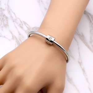 Polished silver titanium steel open bangle with diamond-inlaid cylindrical center
