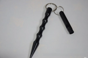 Macro shot of black aluminum tactical kubotan and survival whistle with key ring