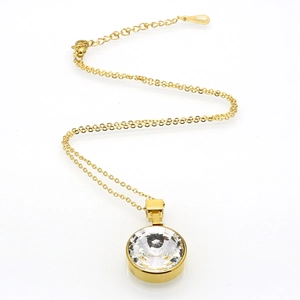 Golden cross chain necklace featuring a round clear faceted zircon crystal pendant