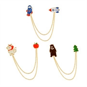 Detail of enamel chain brooch sets featuring astronaut, shiba inu, and bear themes