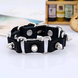 Detail of punk leather bracelet with silver conical rivets and metal ring connectors