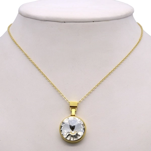 Elegant gold necklace with a round sparkling zircon pendant on a white mannequin