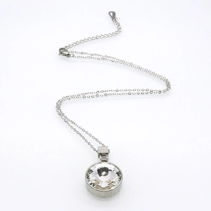 Polished silver chain necklace featuring a large round cubic zirconia pendant on white background