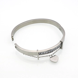 Macro shot of silver bangle featuring cubic zirconia chain and Forever Love heart charm
