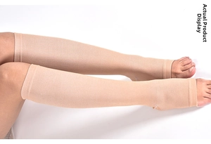 Close-up of compression calf sleeves in beige elastic fabric with pressure texture