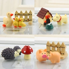 Detail view of miniature resin zoo animal figurines featuring duck, dog, and hedgehog