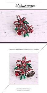 Detail of Christmas bell brooch featuring red and green rhinestones and silver bow knot