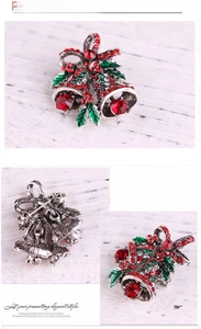 Macro detail of Christmas double bell brooch with red rhinestones and silver alloy base
