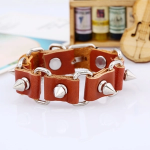 Detail of brown leather punk bracelet featuring silver alloy studs and buckle closure