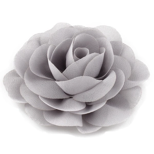 Detailed close-up of a multi-layer grey chiffon flower hairpin with soft fabric texture