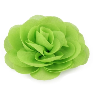 Detailed macro view of vibrant light green chiffon rose hair clip with layered petals