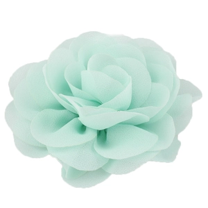 Detailed close-up of a mint green chiffon flower hair clip with layered soft petals