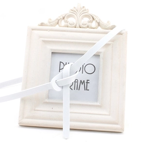 Detail of a thin white leather belt for women showing a stylish knot closure design