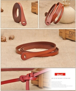 Close-up of red and brown genuine leather skinny belts with tied knot detail for women