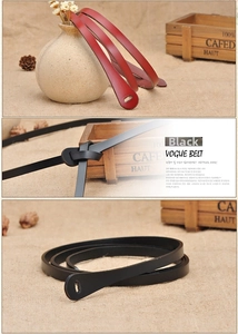 Detail of minimalist slim leather belts in black and red showing the knot style closure