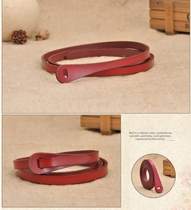 Detailed view of slim dark red leather belt featuring minimalist loop closure design