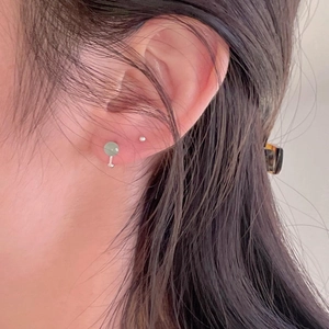 Minimalist 925 sterling silver stud earring set with light green crystal bead on ear lobe