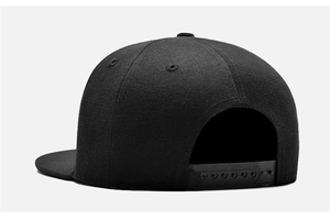 Rear view of black snapback baseball cap showing the adjustable plastic strap closure