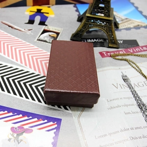 Macro view of a brown rectangular jewelry gift box with textured diamond pattern finish