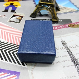 Detailed macro view of the blue rectangle jewelry box with a textured diamond pattern