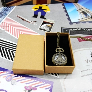 Retro bronze pocket watch with Eiffel Tower relief in a kraft paper jewelry box