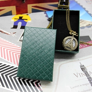 Vintage bronze Eiffel Tower pocket watch necklace inside a green diamond pattern gift box