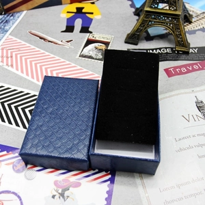 Detailed top view of blue textured jewelry box with black velvet sponge insert lining